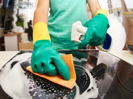 Technician applying safe cleaning practices during carpet treatment